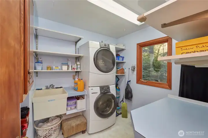 Laundry room with sink, shelving and counterspace.