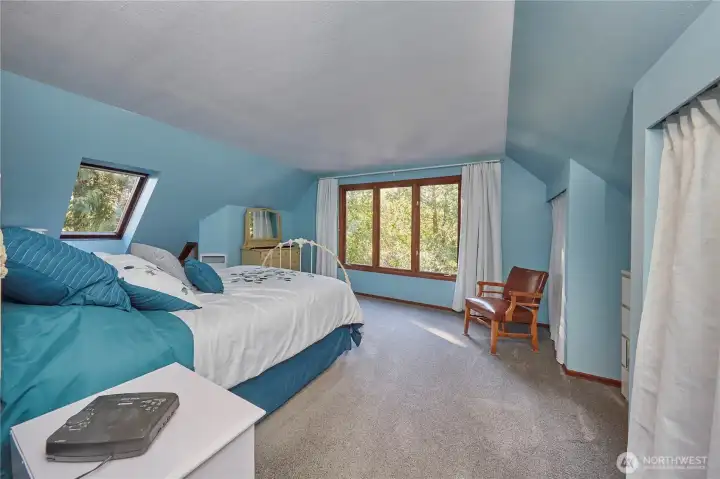 Bedroom #1. Wood windows lookout over driveway.