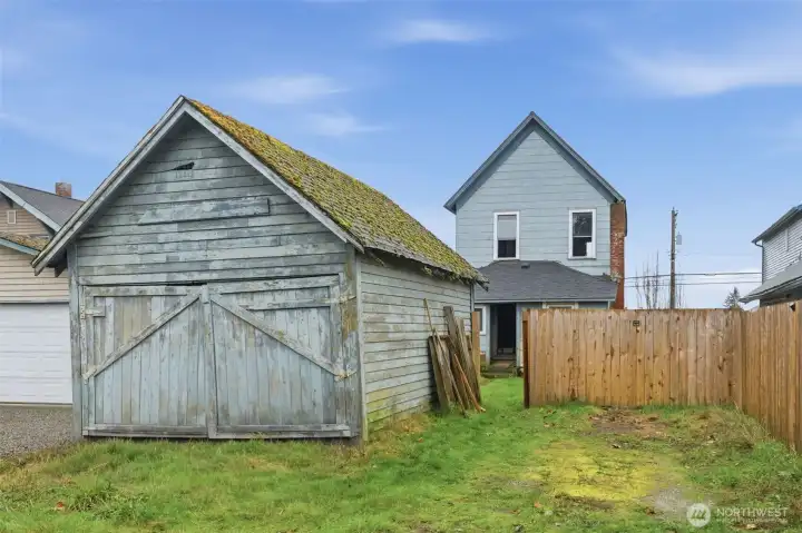 Brand new wood fence fully encloses the backyard.