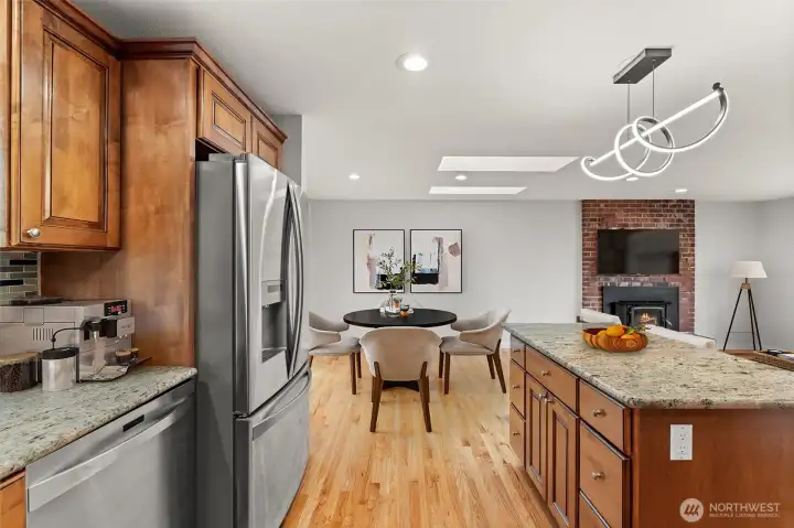 Kitchen skylights fill the space with natural light — granite counters and warm cabinetry