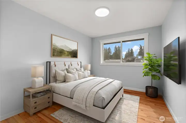 Bedroom 2 — hardwood floors, natural light, fits queen bed comfortably