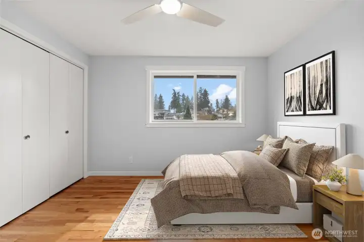 Bedroom 3 — ceiling fan, tree views, hardwood floors