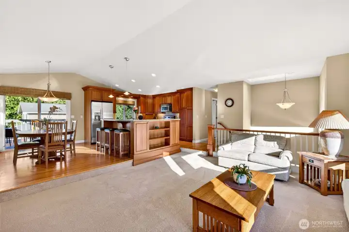 A wide open great room layout that brings kitchen, dining, and living spaces together, ideal for entertaining and everyday flow. Hardwood flooring anchors the kitchen and dining area, while the oversized island creates a natural gathering spot for meals, homework, and hosting. Sliding door access to the deck extends your living space outdoors for grilling and summer dining.