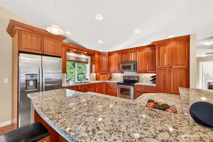 An inviting, highly usable kitchen setup with a large island, substantial counter space, and storage you’ll appreciate day one. The sink window keeps the workspace bright, and the layout provides clear zones for cooking, prep, and gathering.