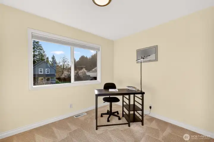 A flexible secondary bedroom with great natural light and comfortable proportions, ideal for a guest room, home office, or workout space. The quiet setting and large window create an inviting place to focus and recharge.