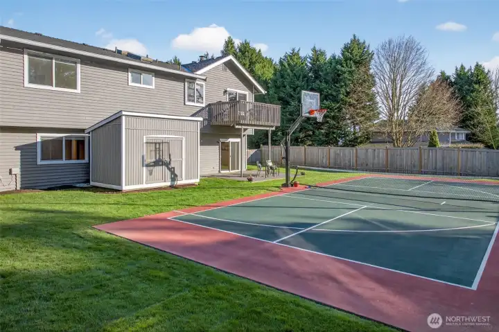 The backyard is built for lifestyle, featuring the sports court as the centerpiece, generous lawn space, and quick access to both the patio and deck. An additional storage structure adds practical utility for gear, tools, and seasonal items, keeping the main living spaces clutter free.