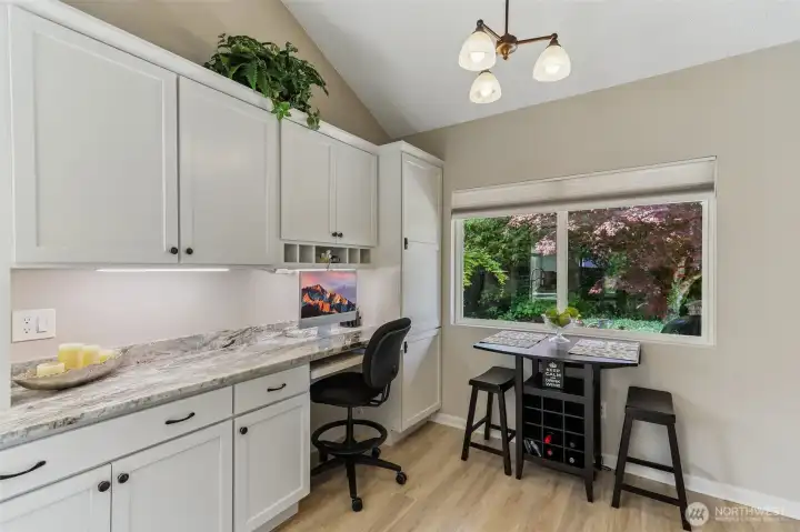 A built-in workstation and casual breakfast nook make it a natural gathering spot.