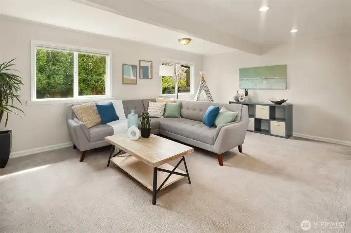 Family room with large windows providing ample natural light throughout.