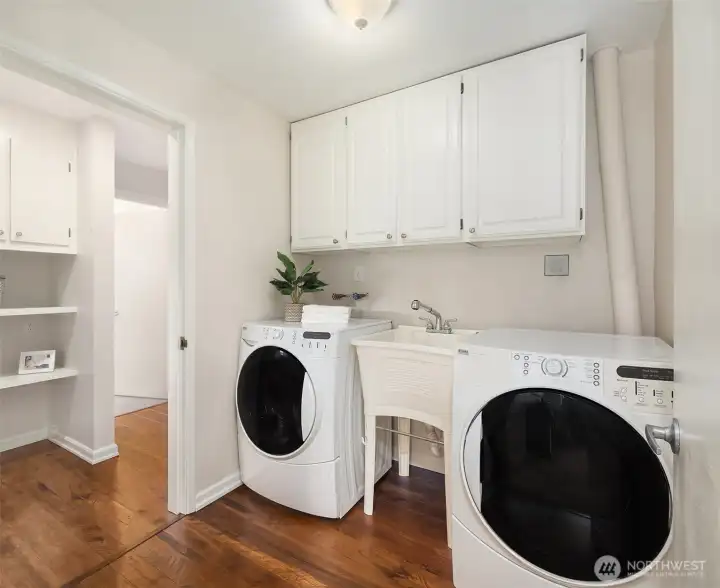 Laundry room with ample storage.
