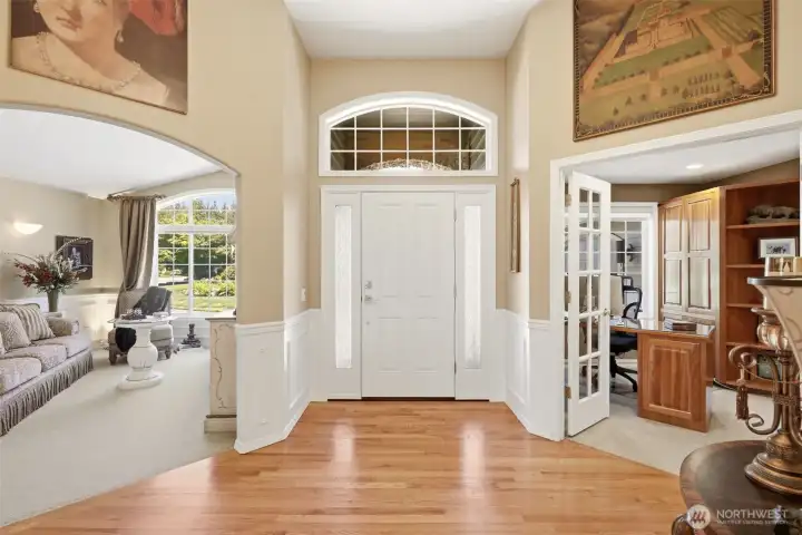 Grand entry with extended High vaulted ceilings and natural hardwood floors that lead to formal living room, dining and office