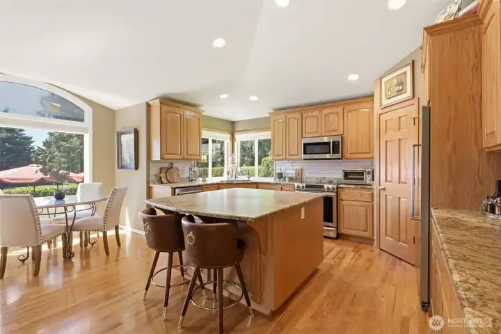 Open bright Kitchen with bump out seating area and center island with bar seating