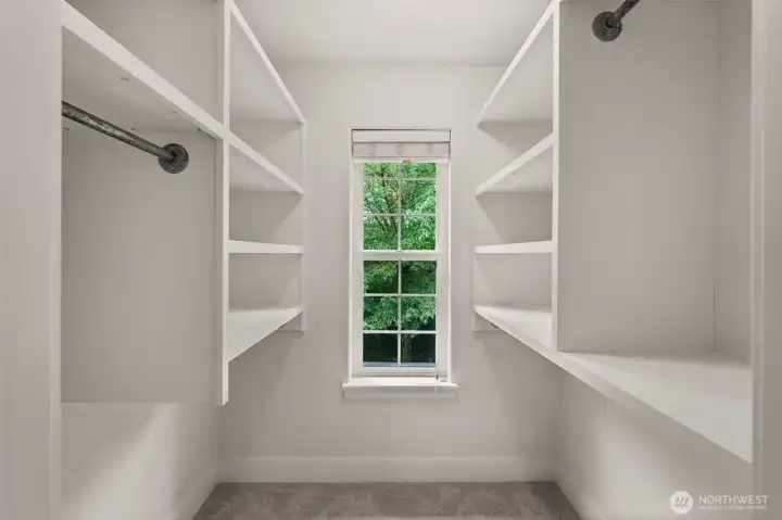primary walk in closet with built ins