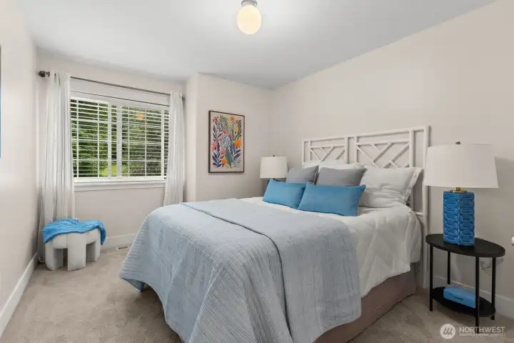 large guest bedroom with lots of natural light