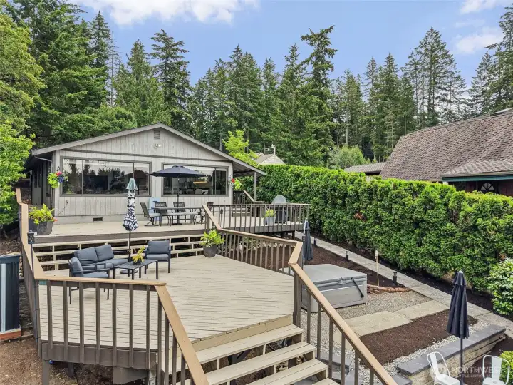 Lake-facing deck with outdoor seating and room to gather.
