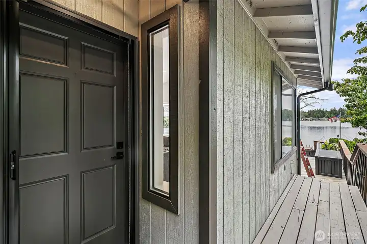 Covered entry and deck area with lake views and outdoor living space.