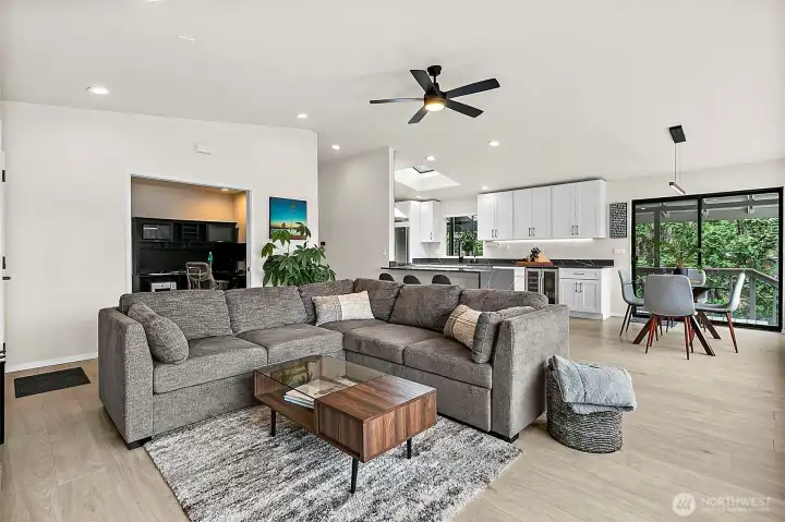Main living area with vaulted ceiling, modern finishes, and open flow to the kitchen.