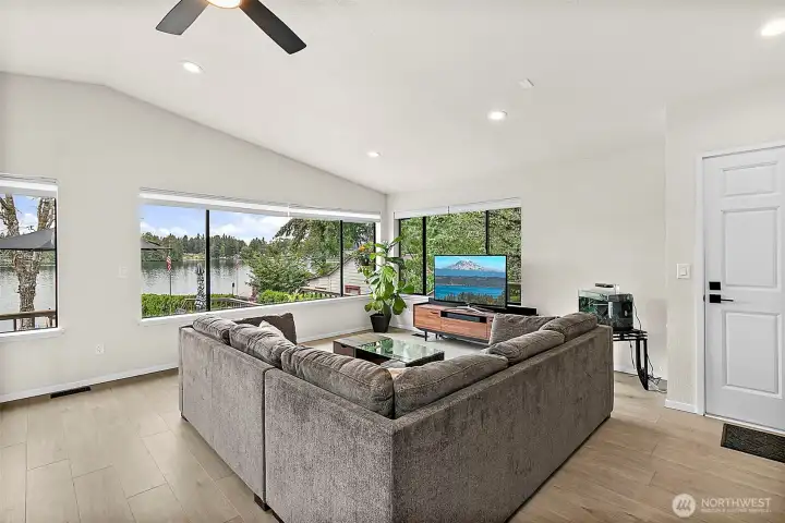 Living room with lake views, large windows, and a comfortable open layout.