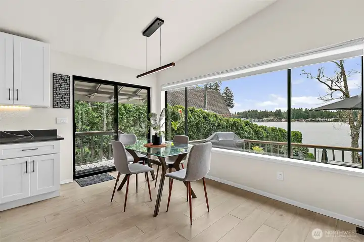Bright dining nook with wide Lake Sawyer views and direct sightlines to the water.