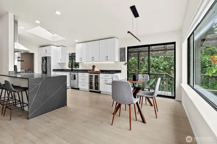 Open kitchen and dining area with lake-facing windows and easy flow to the main living space.