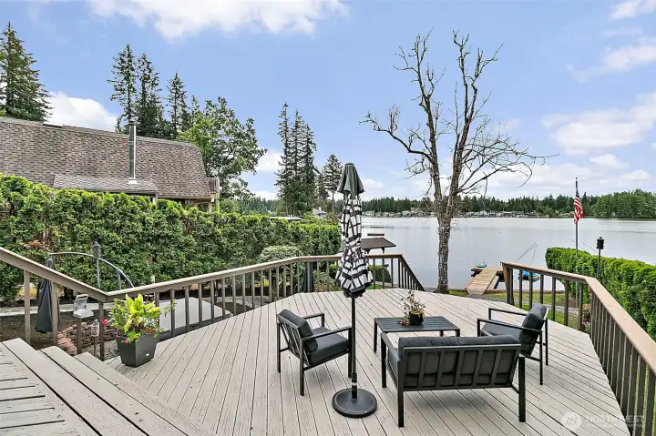 Deck stairs leading down toward the lakefront yard and dock.