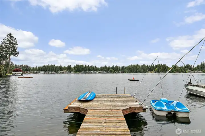 Lakefront dock with space for kayaks, paddleboards, and water toys.