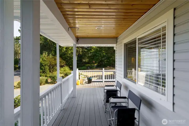 Relax on the welcoming covered front porch and enjoy a peek-a-boo water view in the distance.