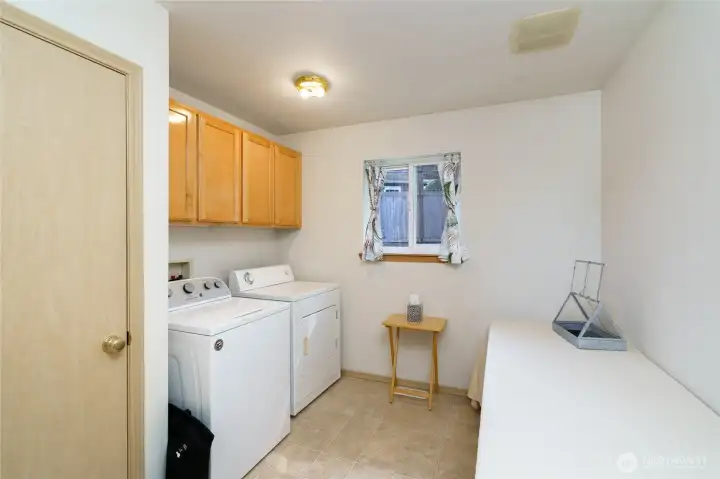 Laundry room with closet for extra storage.
