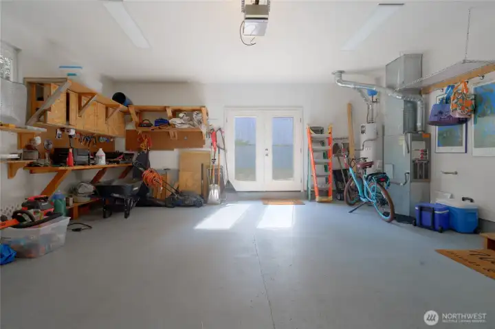 Two car garage with double doors leading to the backyard.