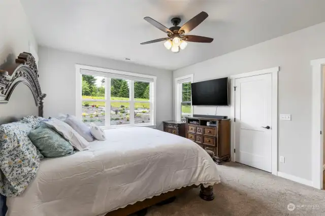 Generous size Primary suite, with ceiling fan & walk in closet with custom closet systems.