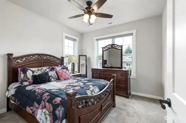 2nd bedroom with custom closet, custom blinds & ceiling fan.
