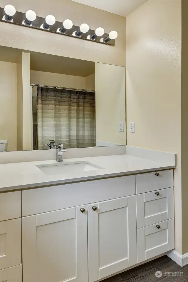 The main full bath was beautifully updated in 2019 and is centrally located between the bedrooms.  Durable laminate hardwood flooring provides easy clean-up.