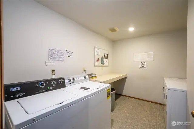 Laundry room with two washers and two dryers.