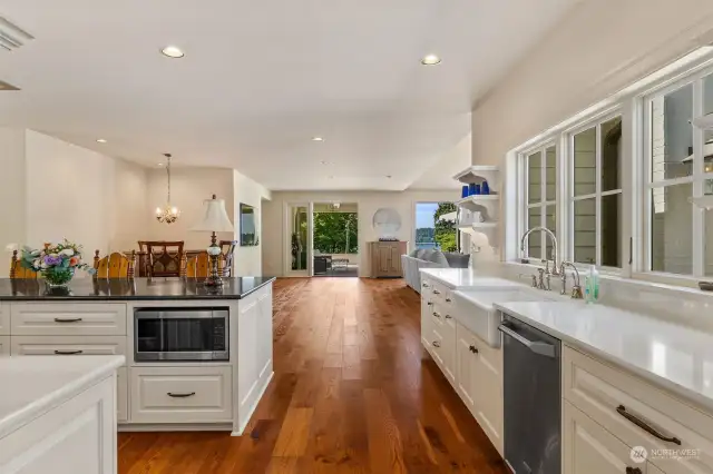 Farm sink and custom open shelving with lovely view out the abundance of kitchen windows.