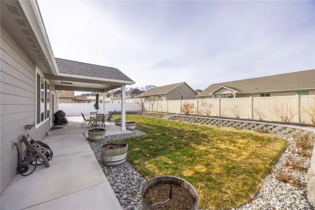 Landscaped with fruit tree and blueberry bushes.