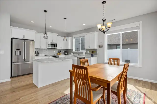 Dining and kitchen overlooking beautifully landscapped yard