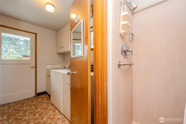 Through a door on the right is a walk-in shower and toilet area.