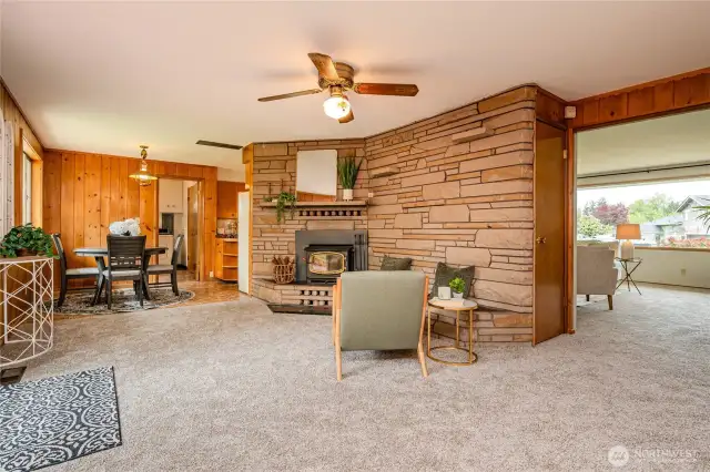 From this angle you can see the cozy wood burning fireplace insert and the opening to the Living Room. To the left is a slider to the backyard deck.