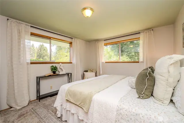 The comfortable Primary Bedroom offers plush new carpeting, pretty front yard views and built-in cedar closet & drawers.