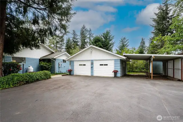 Expansive blacktop driveway, detached 2-car Garage (24'x28'), 2-bay carport (19.5'x29') and RV parking (not pictured here) (11'8"x 30')