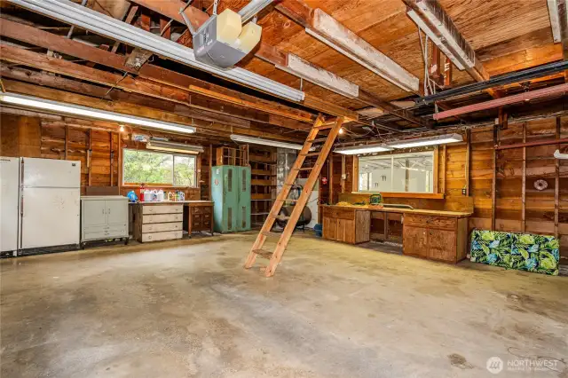 This 28'x24' 2-car Garage/Shop is the pefect space for parking vehicles or working on projects, with built-in workbench & woodstove. There are numerous power outlets and flourescent light fixtures AND there's STORAGE galore!