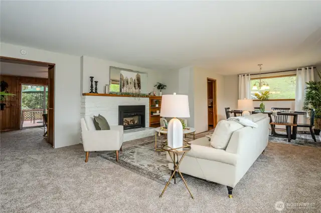 Easy Main Floor Living with one bedroom upstairs. This photo shows the flow from Living to Dining, Kitchen, Nook and Family Room.