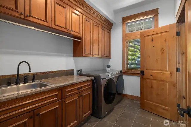 Perfectly appointed utility room adjacent to the master closet and on the main level with abundant cabinet space.