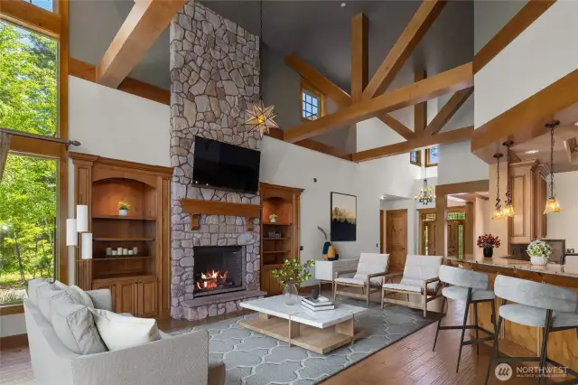 Soaring ceilings, exposed beams, and a grand stone fireplace create the ultimate mountain-modern retreat—where rustic charm meets refined living.