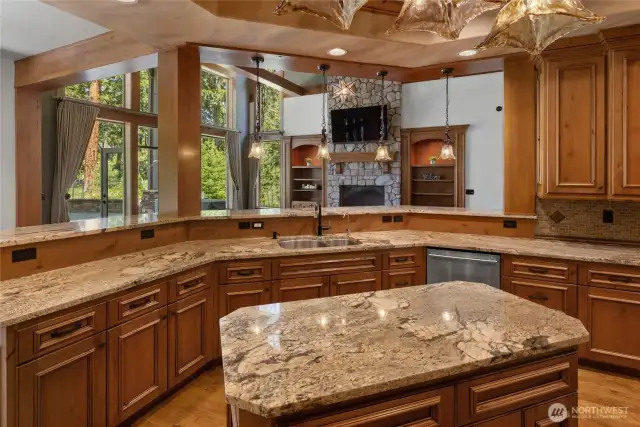 Enjoy the incredible view from the kitchen looking out over the great room, one of two dining spaces and to the seamless transition between indoor and outdoor  living.