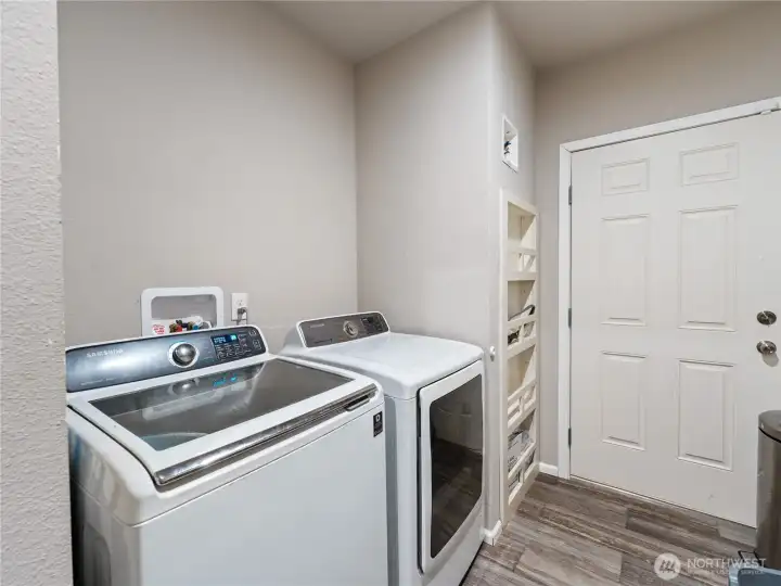 Laundry room with closeted hot water heater