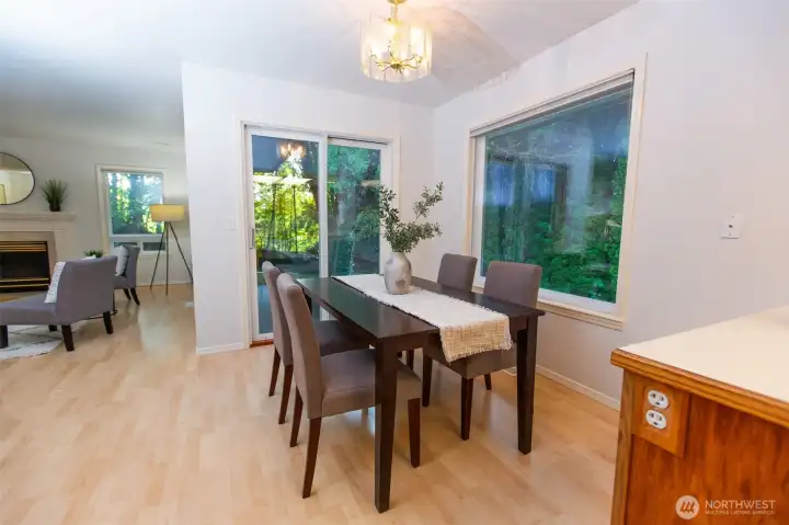 Dining room also has big windows and nature views, access to back patio.