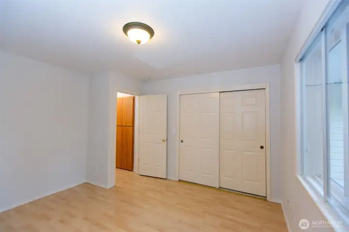 Another view of second bedroom - with large linen storage in hallway just outside the door.