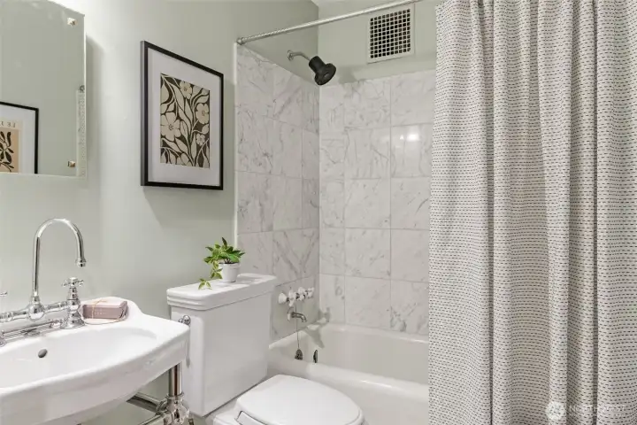 Adorably cute bathroom with nice finishes.