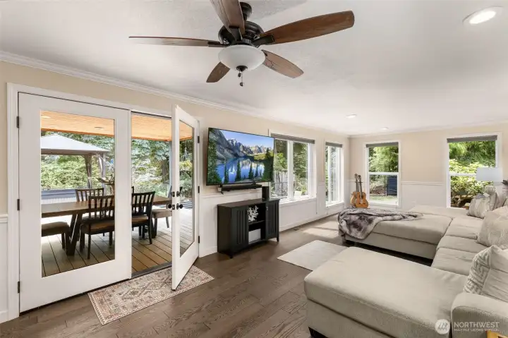 Family room leads to expansive deck, Jacuzzi, firepit and gardens through French doors!