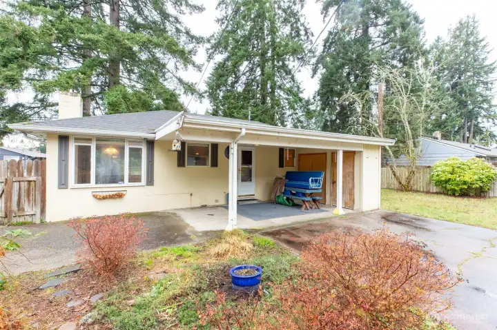 Back covered patio. Fenced gate on left goes to driveway